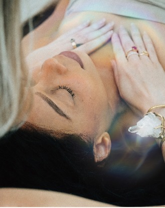 A private session in progress, hands resting gently with a crystal